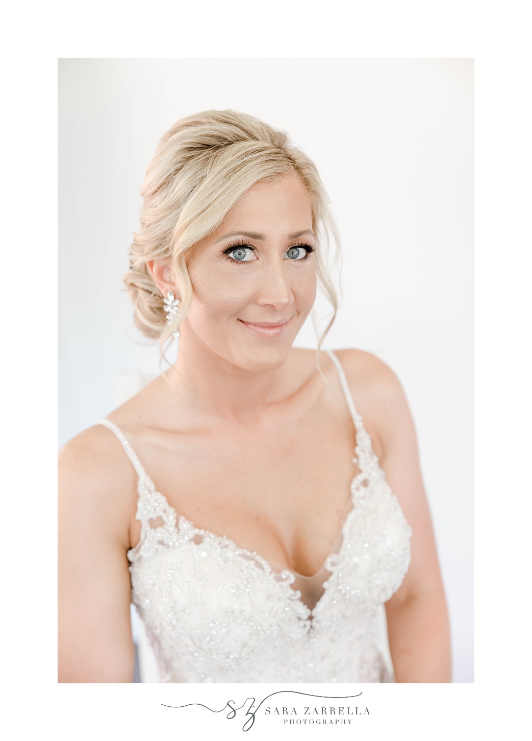 bride smiles with v-neck wedding gown with spaghetti straps at Harbor Lights