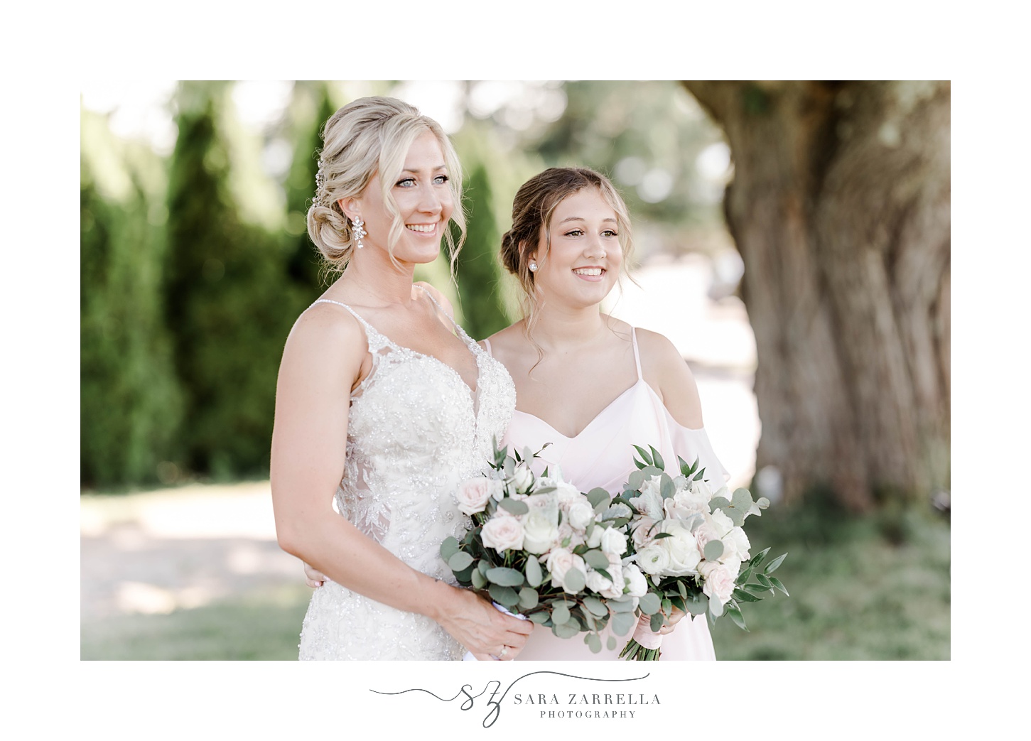bride and sister smile hugging together on wedding day at Harbor Lights