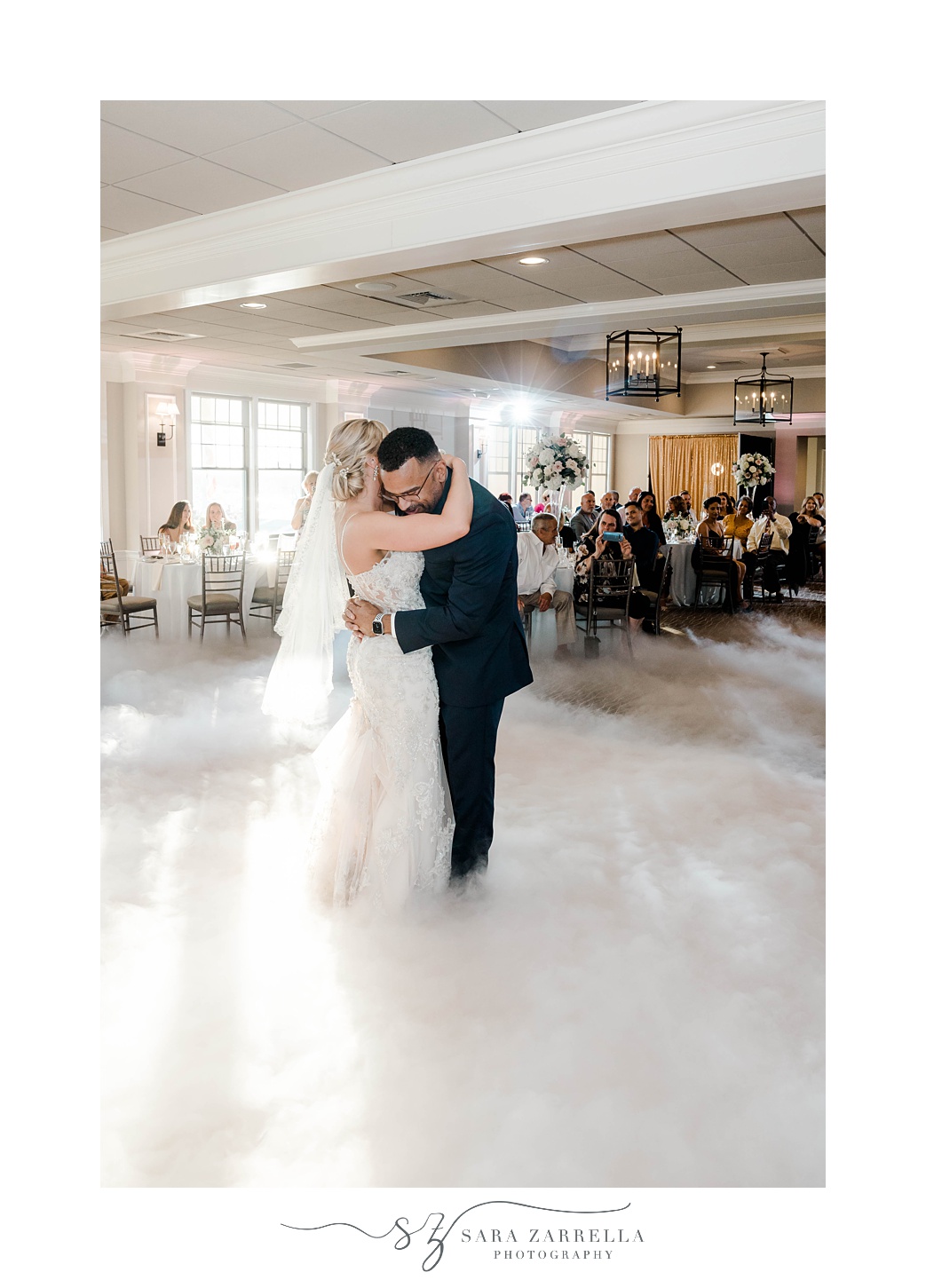 couple hugs during first dance with fog around them
