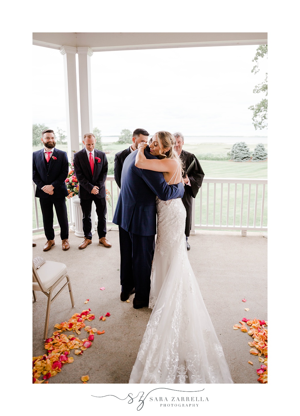 bride and dad hug during ceremony at Quidnessett Country Club