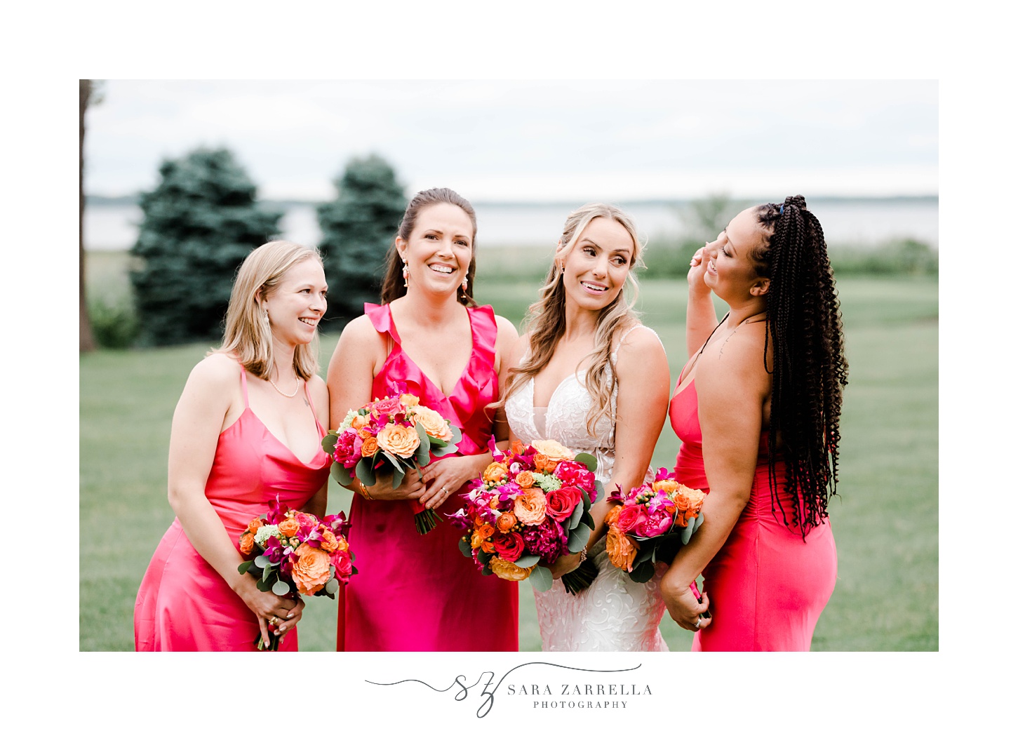 bride laughs with bridesmaids in pink gowns at Quidnessett Country Club