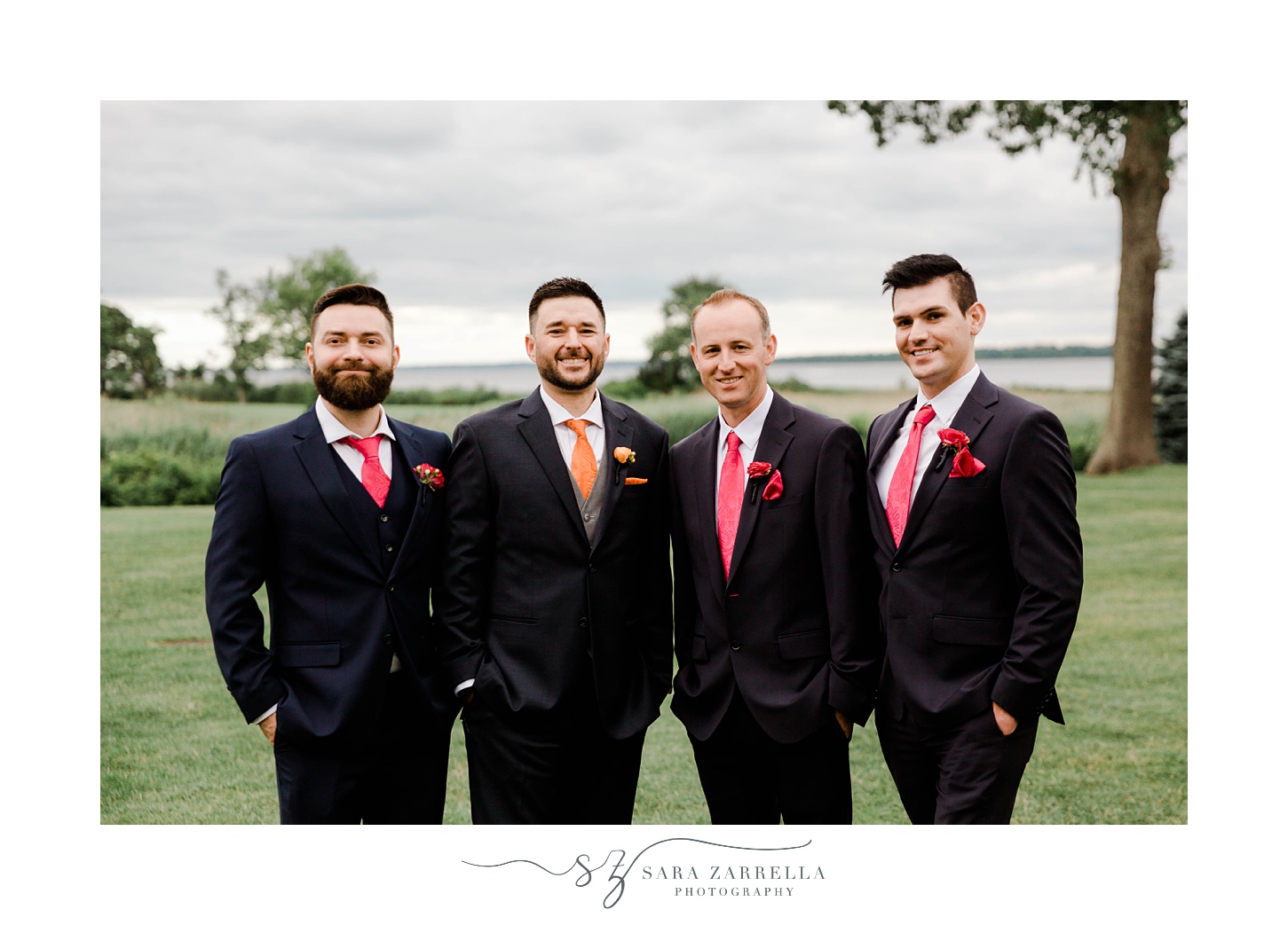 groom and groomsmen stand together at Quidnessett Country Club 