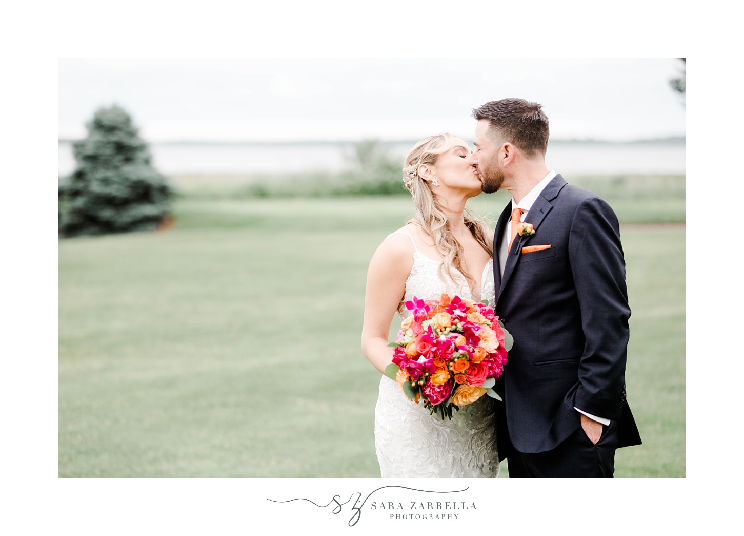 newlyweds kiss during portraits at Quidnessett Country Club