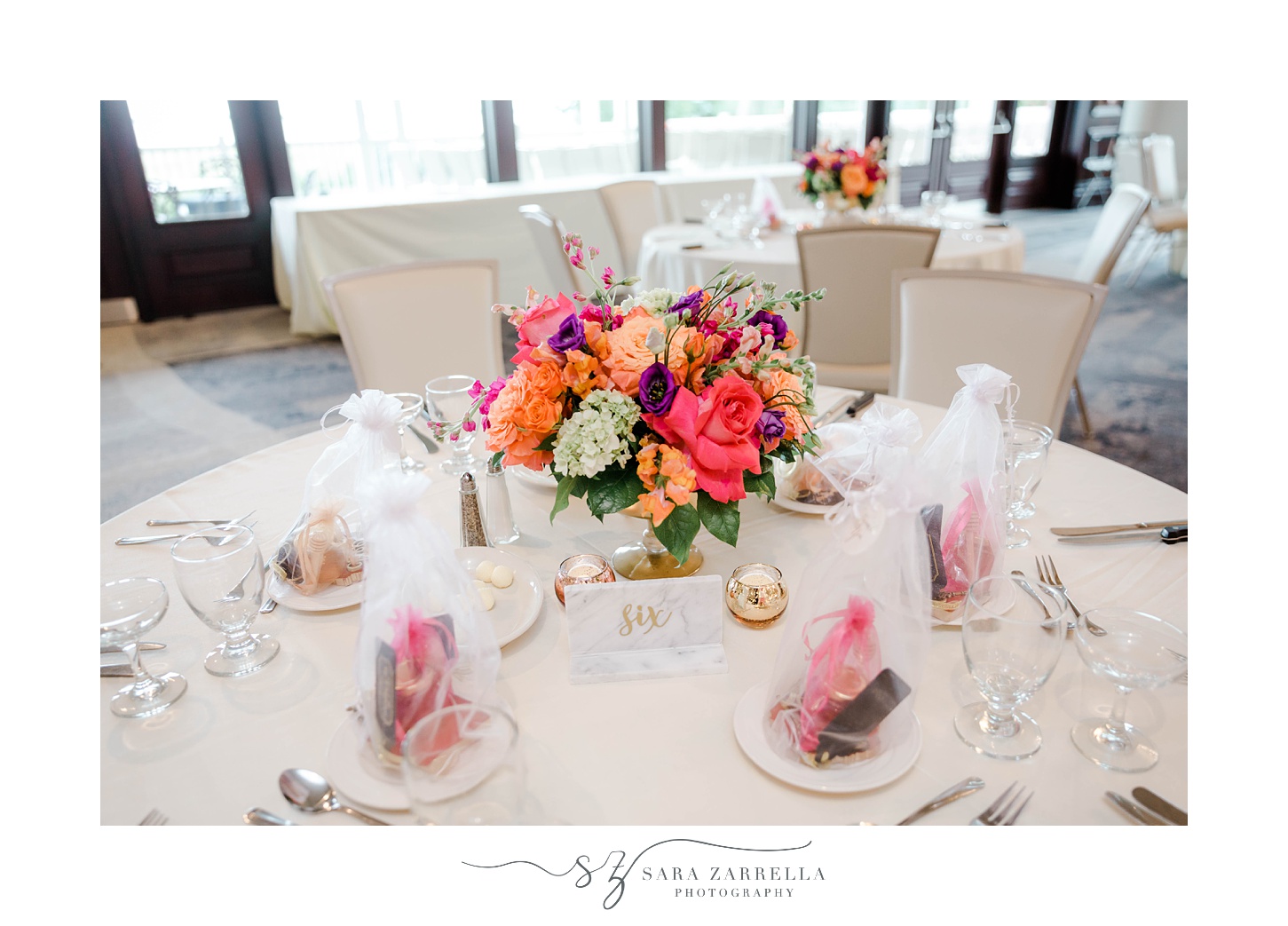 bright pink and orange floral centerpieces for tropical inspired reception at Quidnessett Country Club