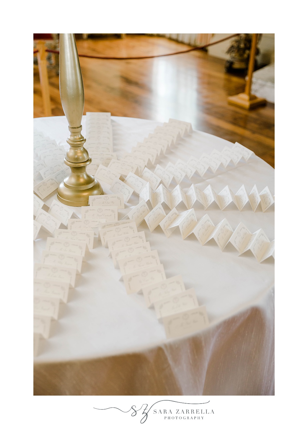 seating cards around table with gold centerpiece 