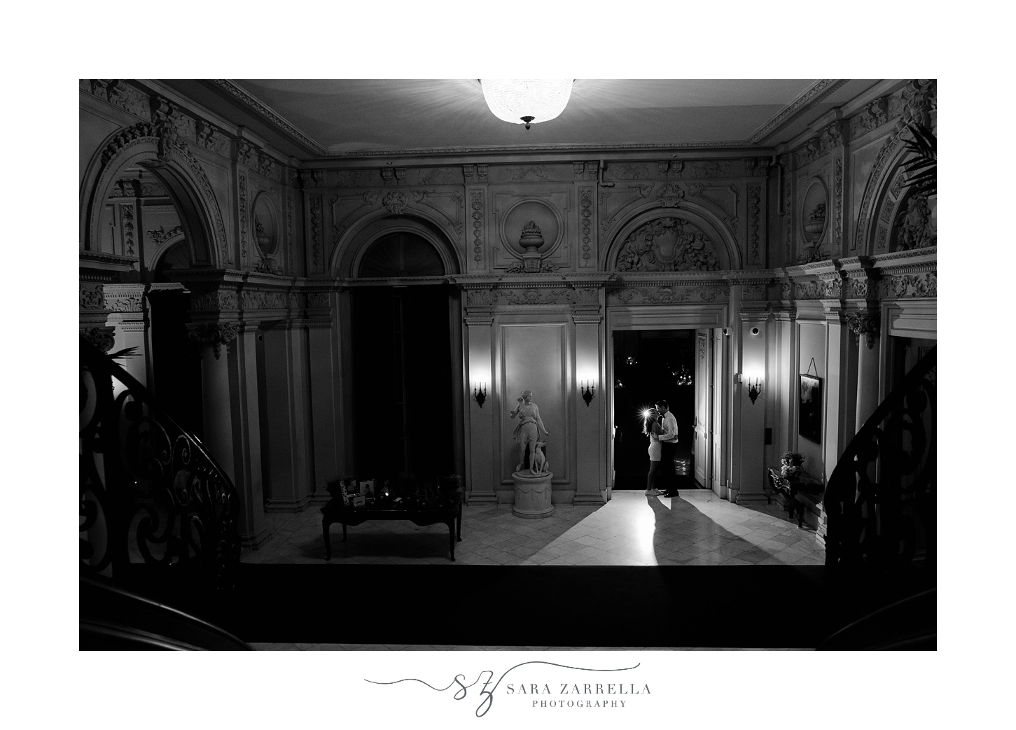 bride and groom kiss in ballroom at Rosecliff Mansion