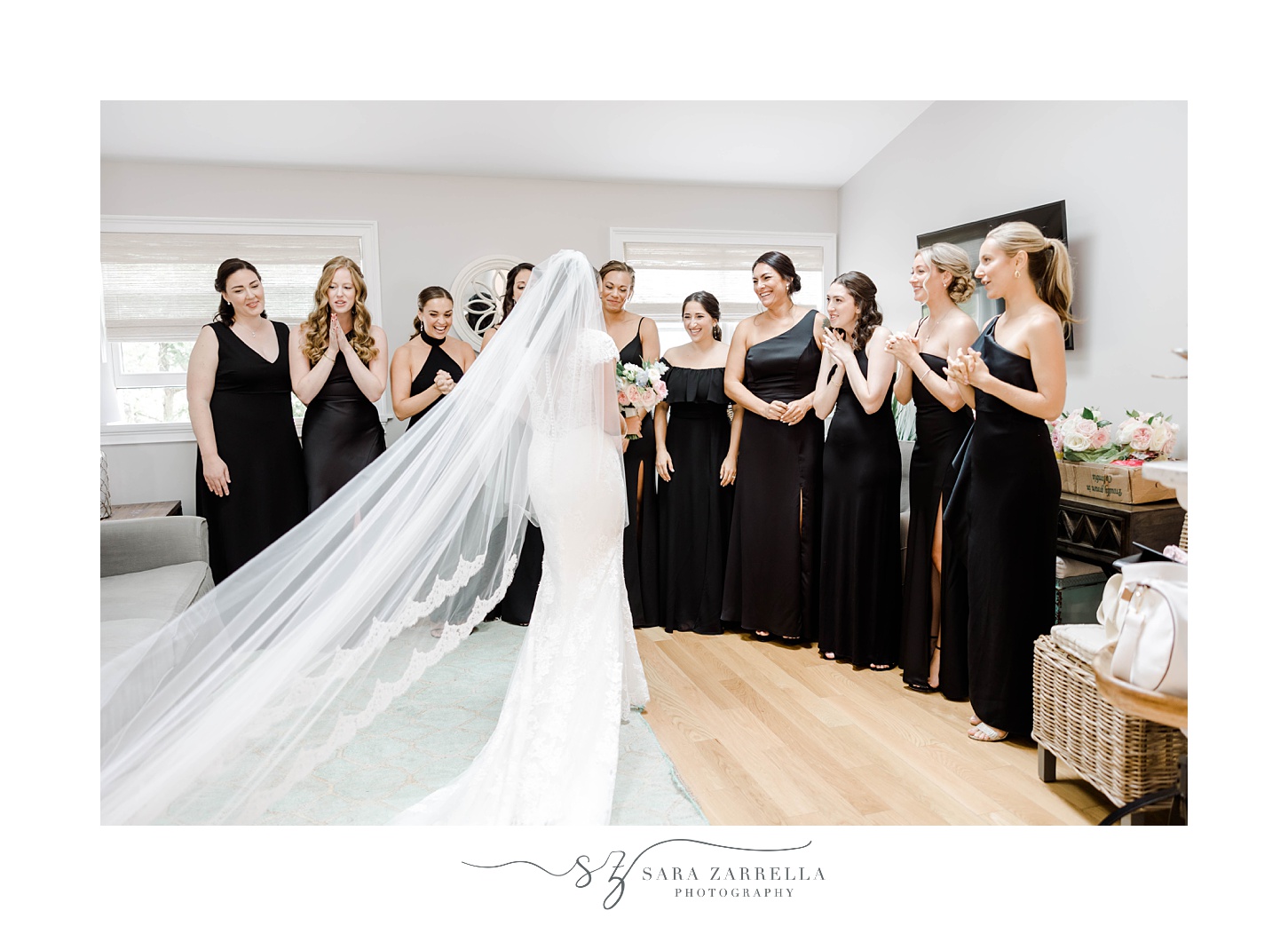 bride approaches bridesmaids in black gowns for first look