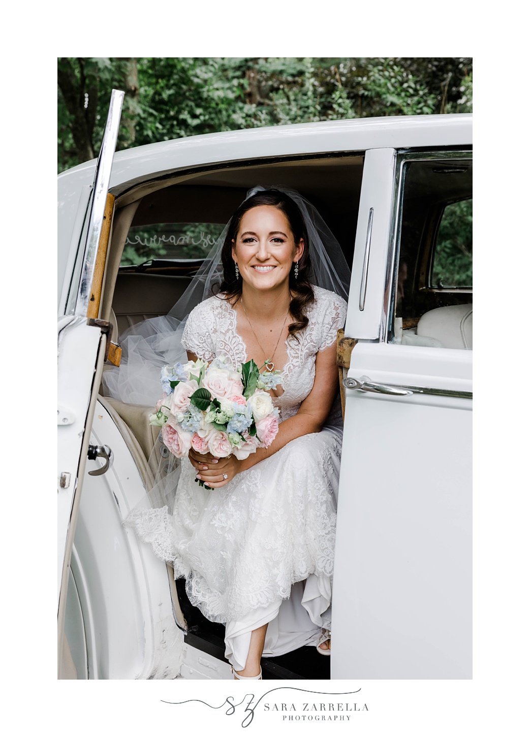 bride steps out of classic car for Rosecliff Mansion wedding