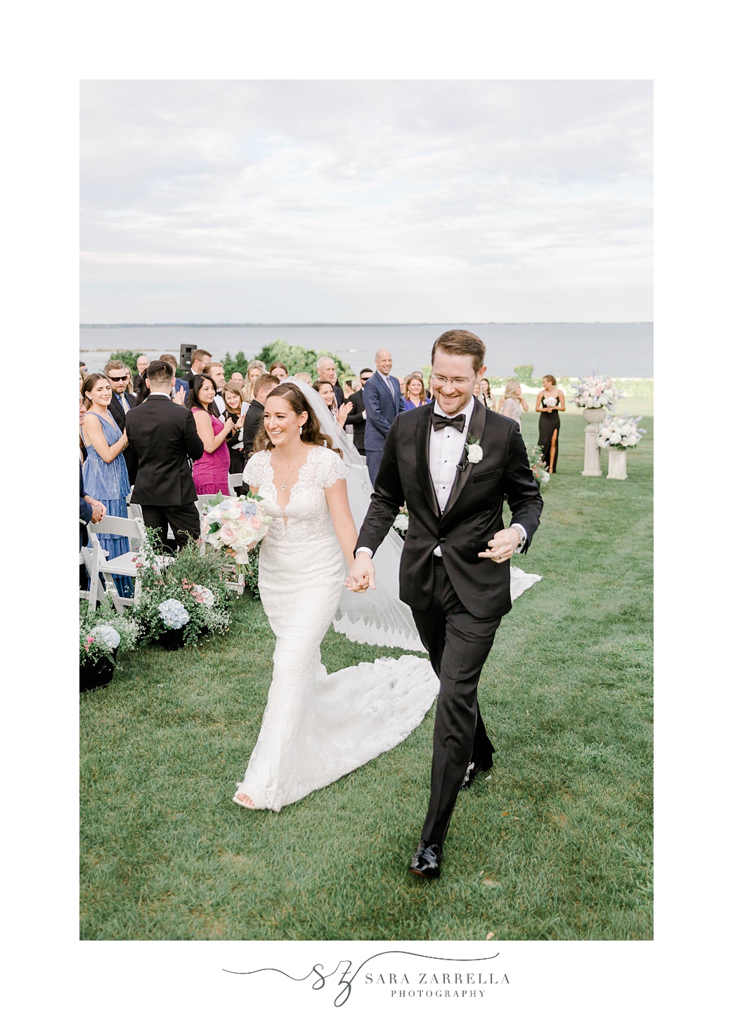 newlyweds leave waterfront ceremony at Rosecliff Mansion