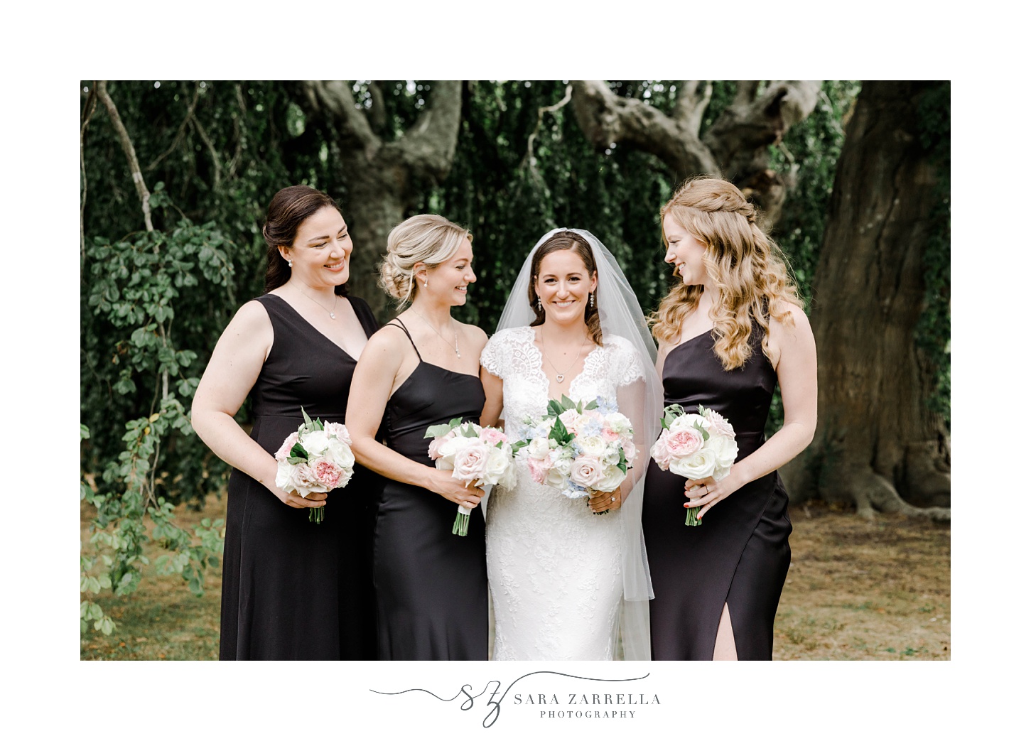 bride poses with bridesmaids in black gowns at The Elms