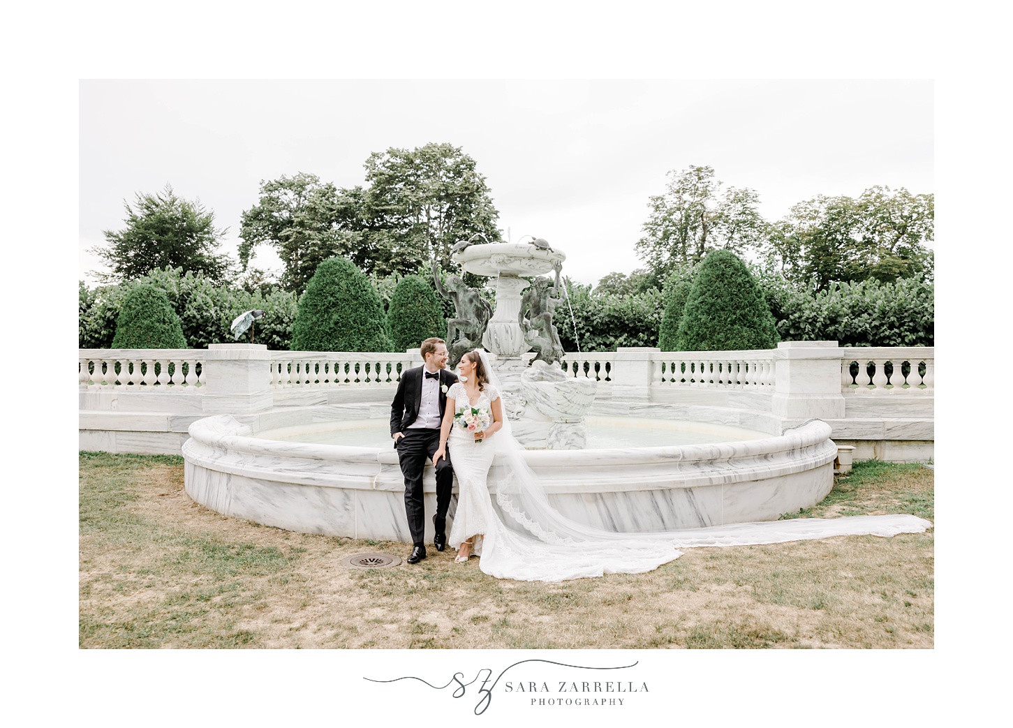 bride and groom sit on fountain at The Elms
