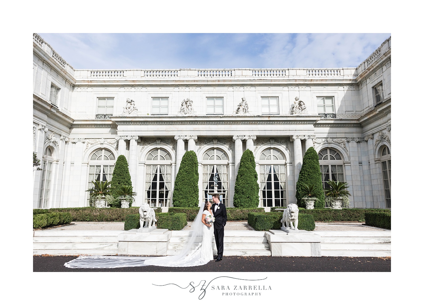 bride and groom stand on steps at Rosecliff Mansion