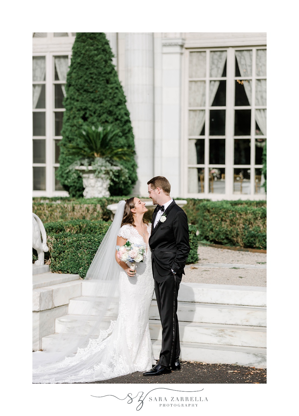 bride smiles up at groom at Rosecliff Mansion