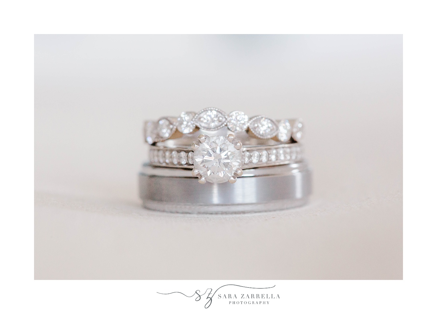 diamond and silver wedding bands stacked on top of each other 