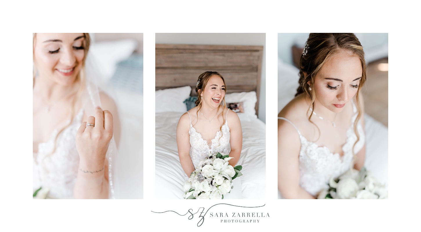 bride laughs while holding bouquet of white flowers on bed