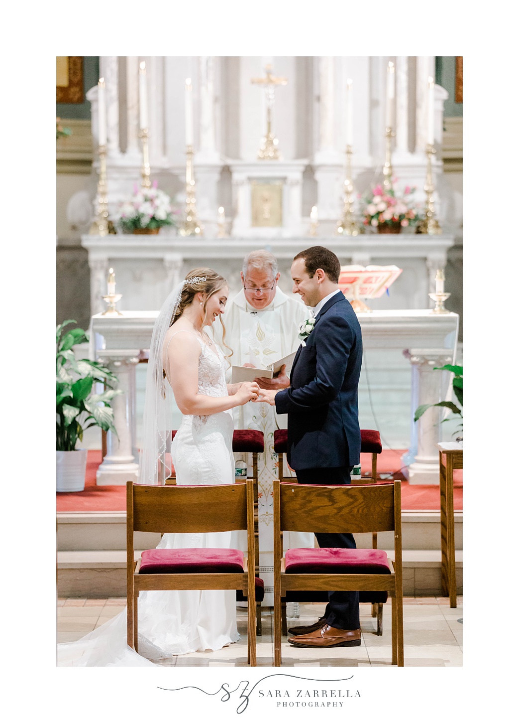 newlyweds exchange rings during traditional Catholic Church wedding in Rhode Island