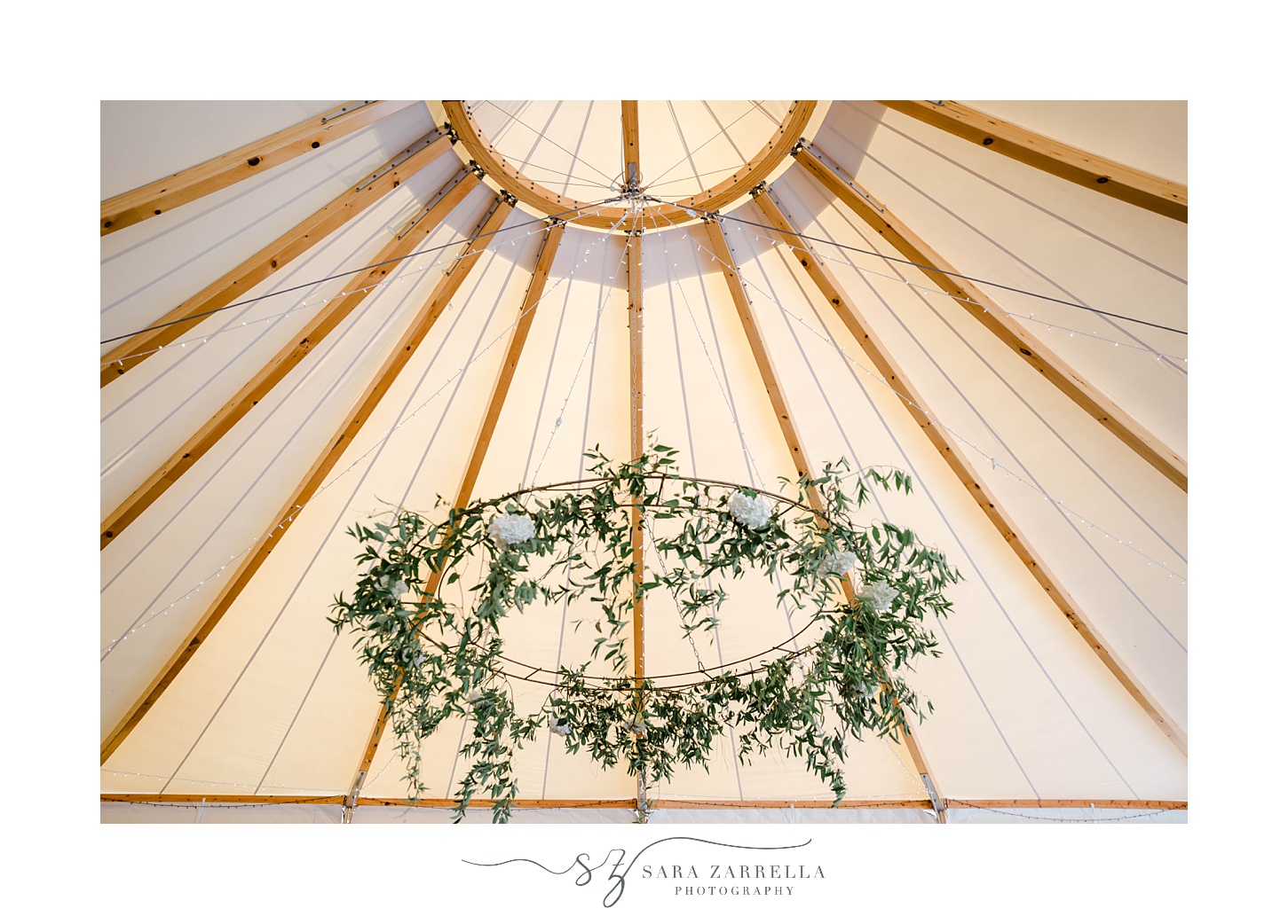 hanging floral chandelier inside tent at The Bohlin