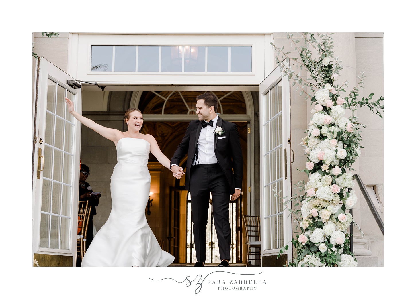 newlyweds walk onto balcony during reception at Aldrich Mansion