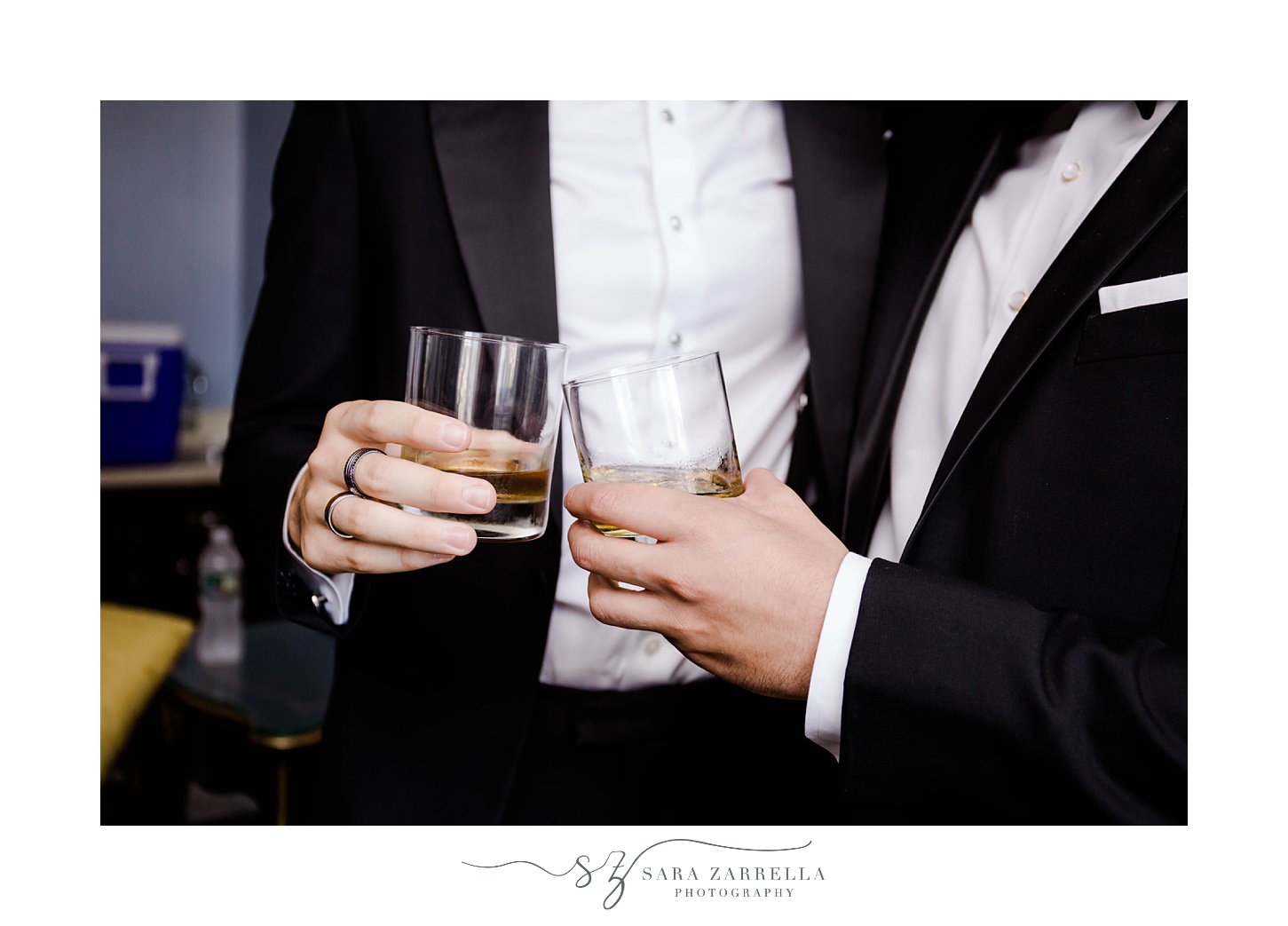 groom toasts drink with groomsman