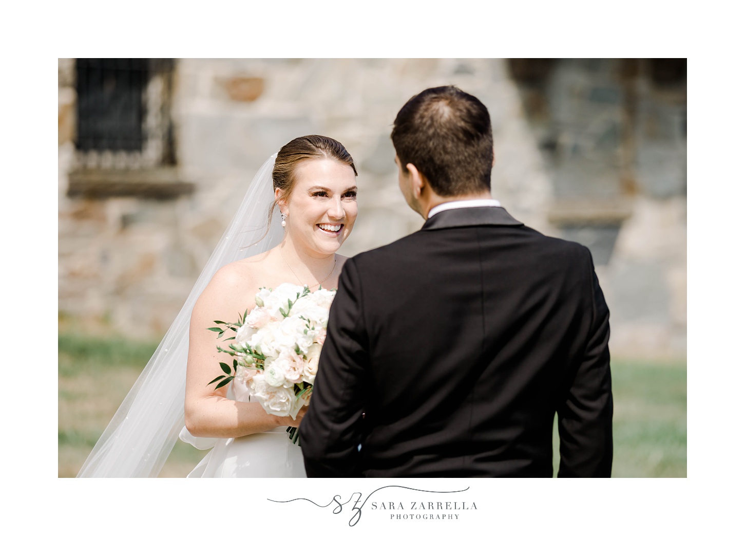 groom smiles at bride during first look at Aldrich Mansion