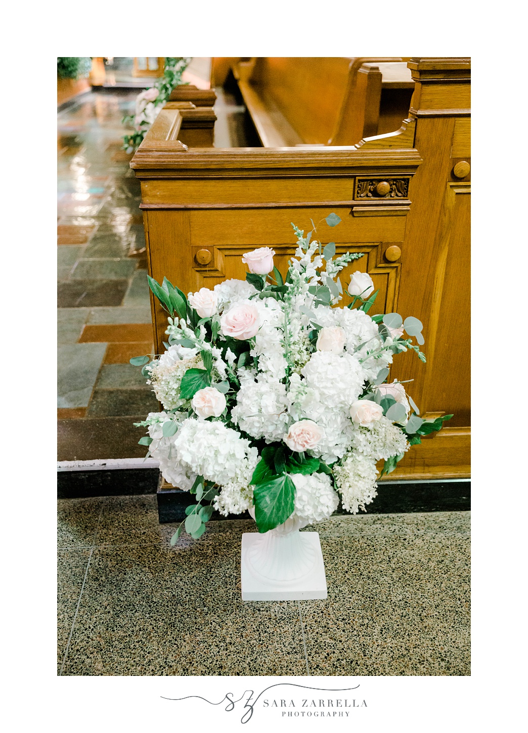 floral bouquet next to pew in Aldrich Mansion chapel
