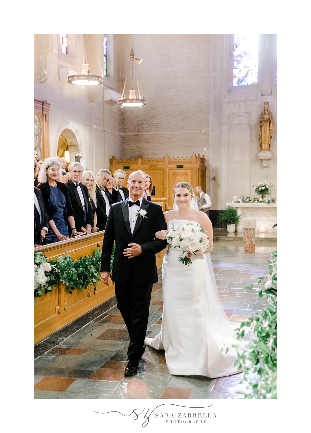 bride and father walk through Aldrich Mansion chapel