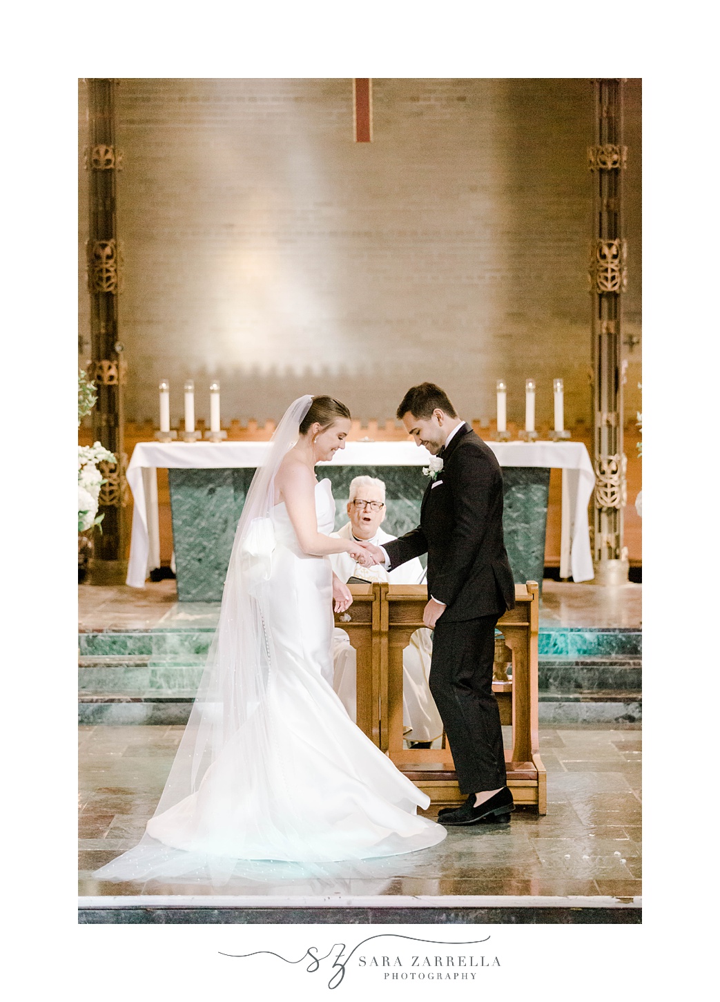 bride and groom exchange rings during traditional ceremony at Aldrich Mansion chapel
