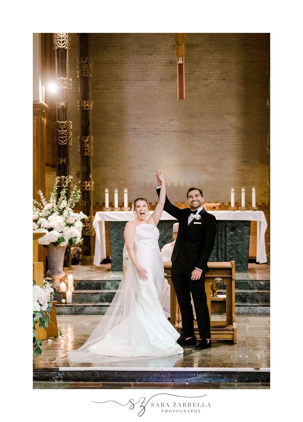 bride and groom cheer at alter after traditional ceremony at Aldrich Mansion chapel
