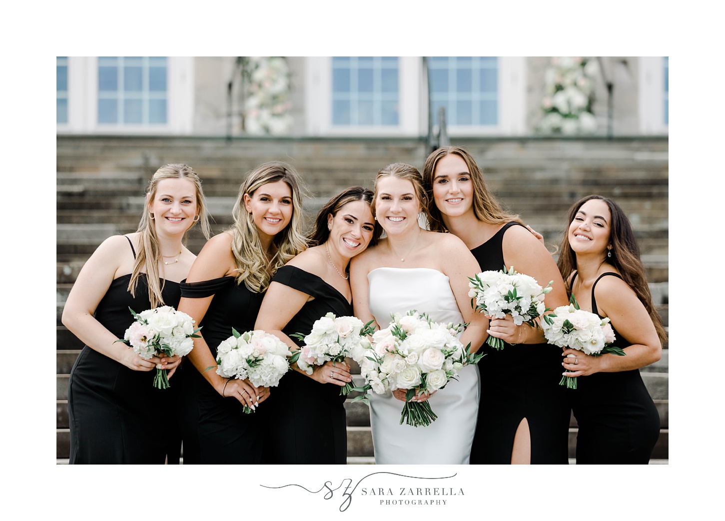 bride and bridesmaids smile leaning together in Warwick RI