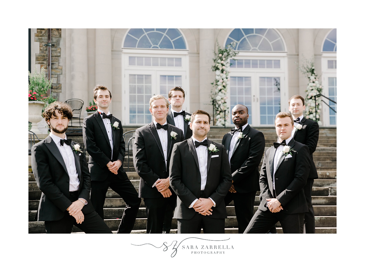 groom and groomsmen pose in classic black tuxes