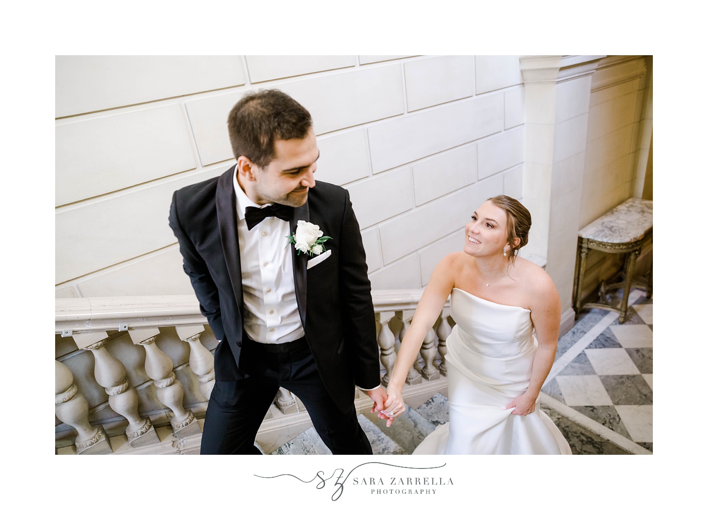 groom leads bride up staircase inside Aldrich Mansion