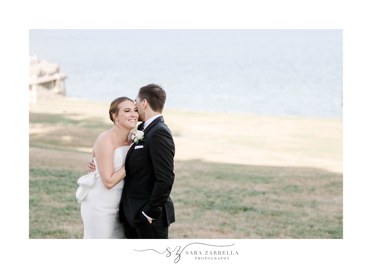 groom kisses bride's forehead standing on lawn at Aldrich Mansion