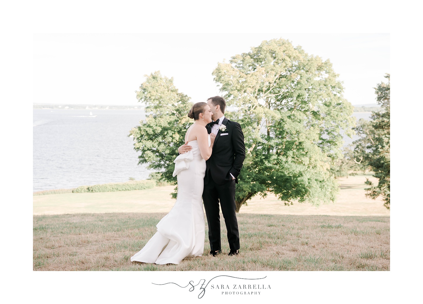 bride and groom kiss on lawn at Aldrich Mansion