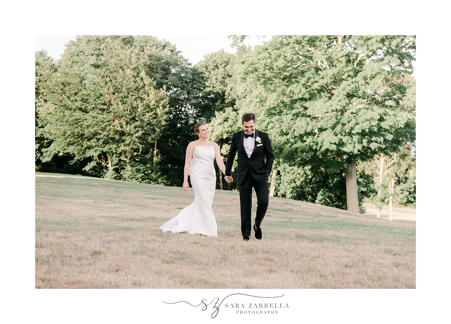 bride and groom walk down lawn at Aldrich Mansion