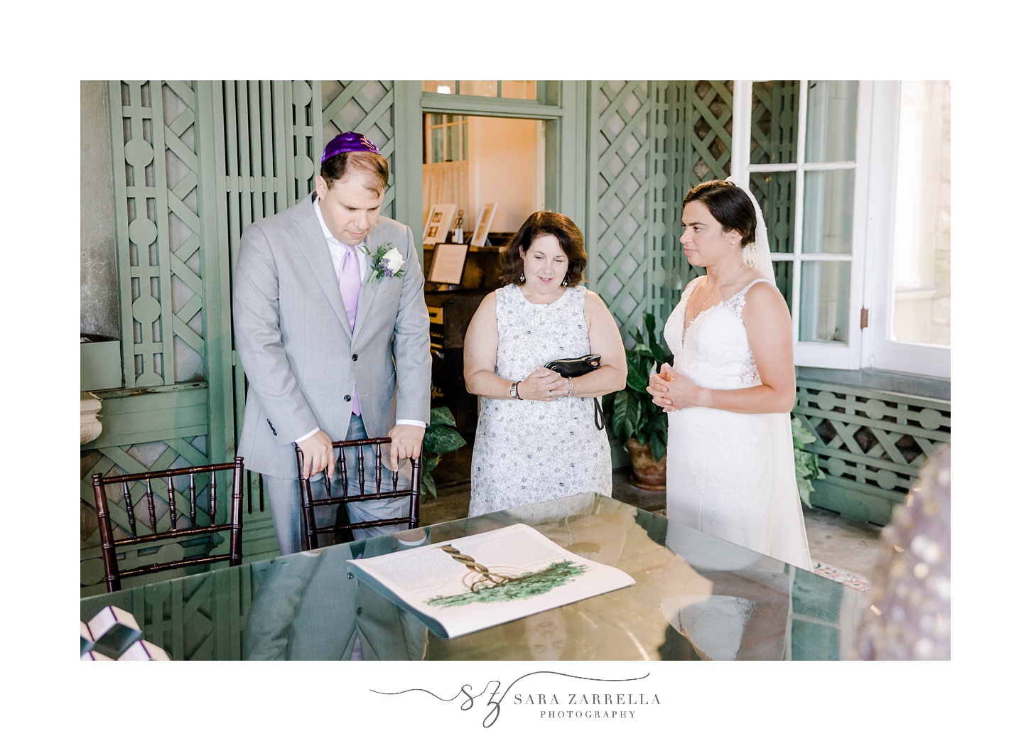 bride and groom prepare to sign their Ketubah