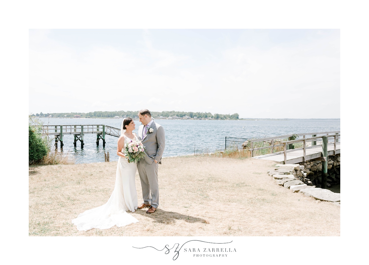 bride and groom stand in front of bay in Bristol RI