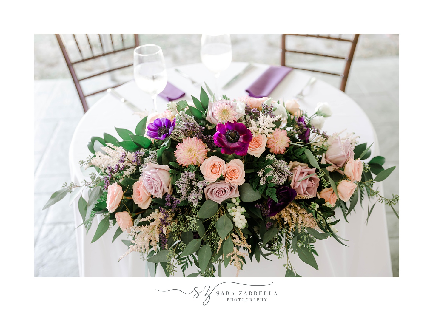 pink and purple floral arrangement on sweetheart table at Blithewold Mansion