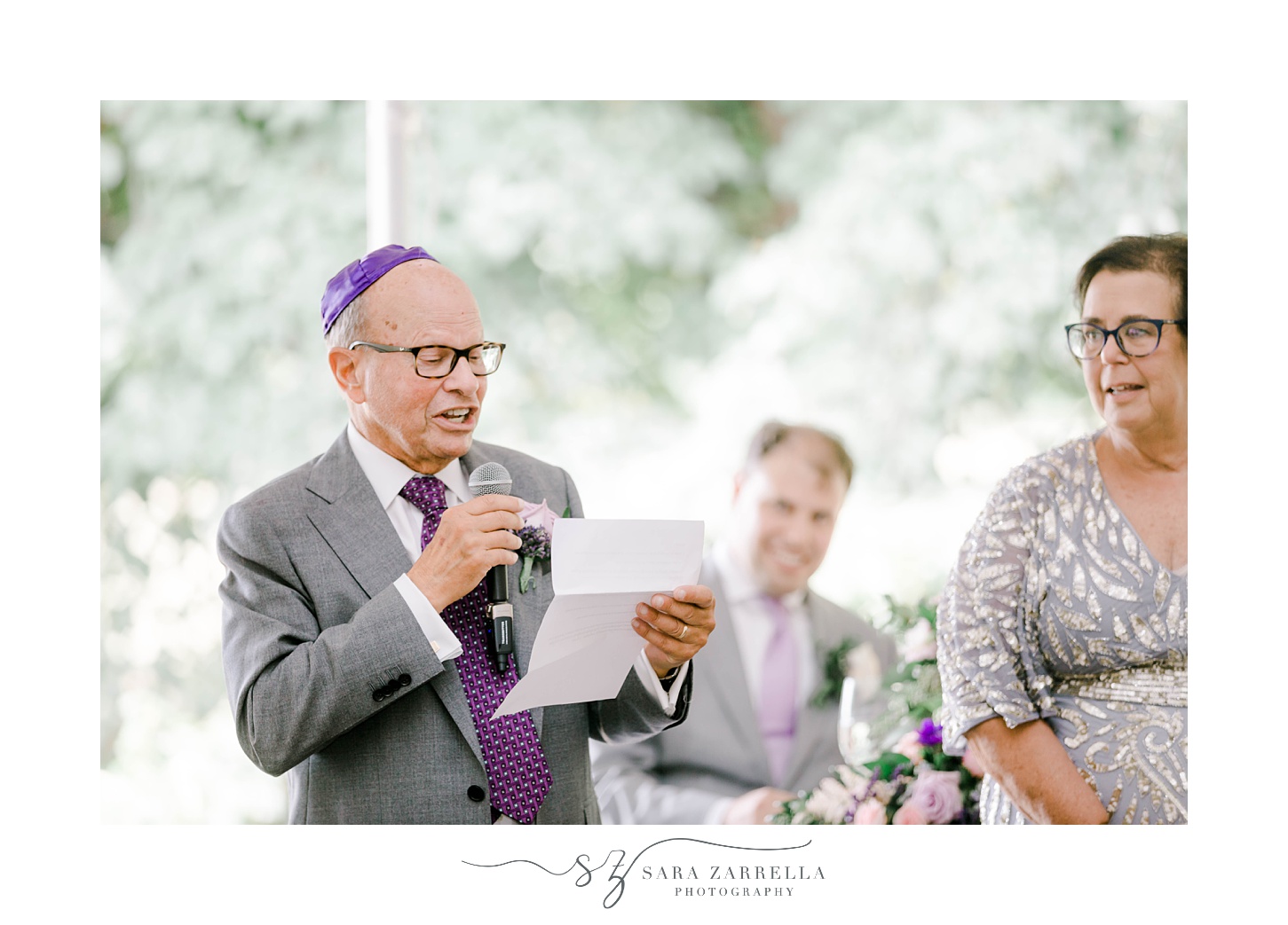 father in purple Yamacca reads speech during wedding reception 