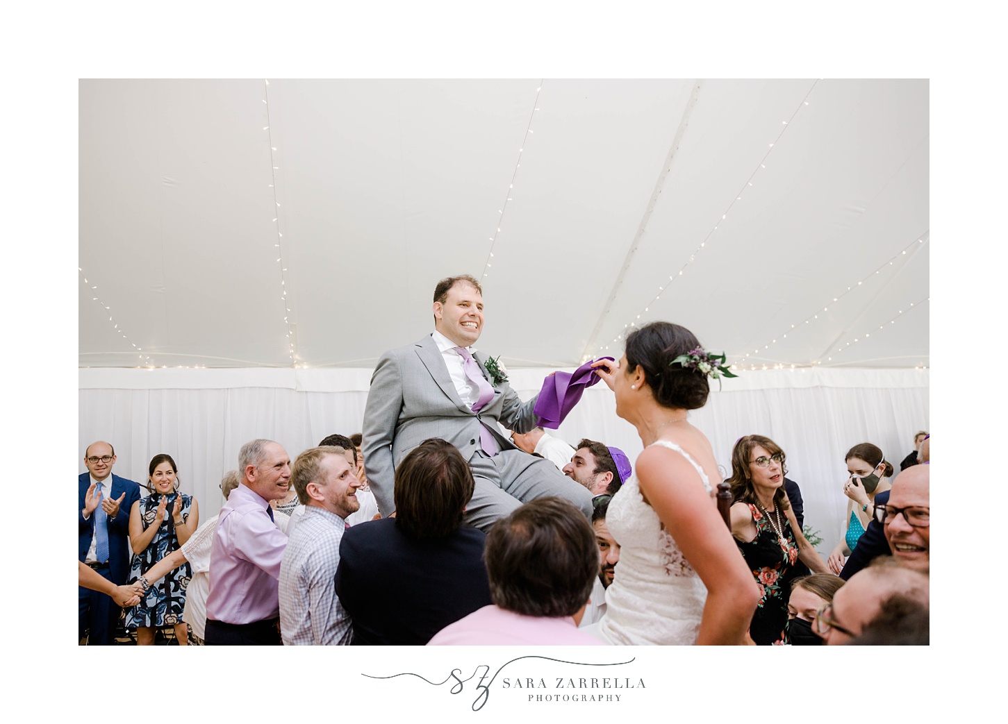 newlyweds lifted in chairs for hora at Blithewold Mansion