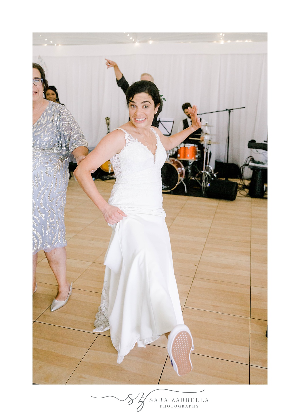 bride dances showing off tennis shoes