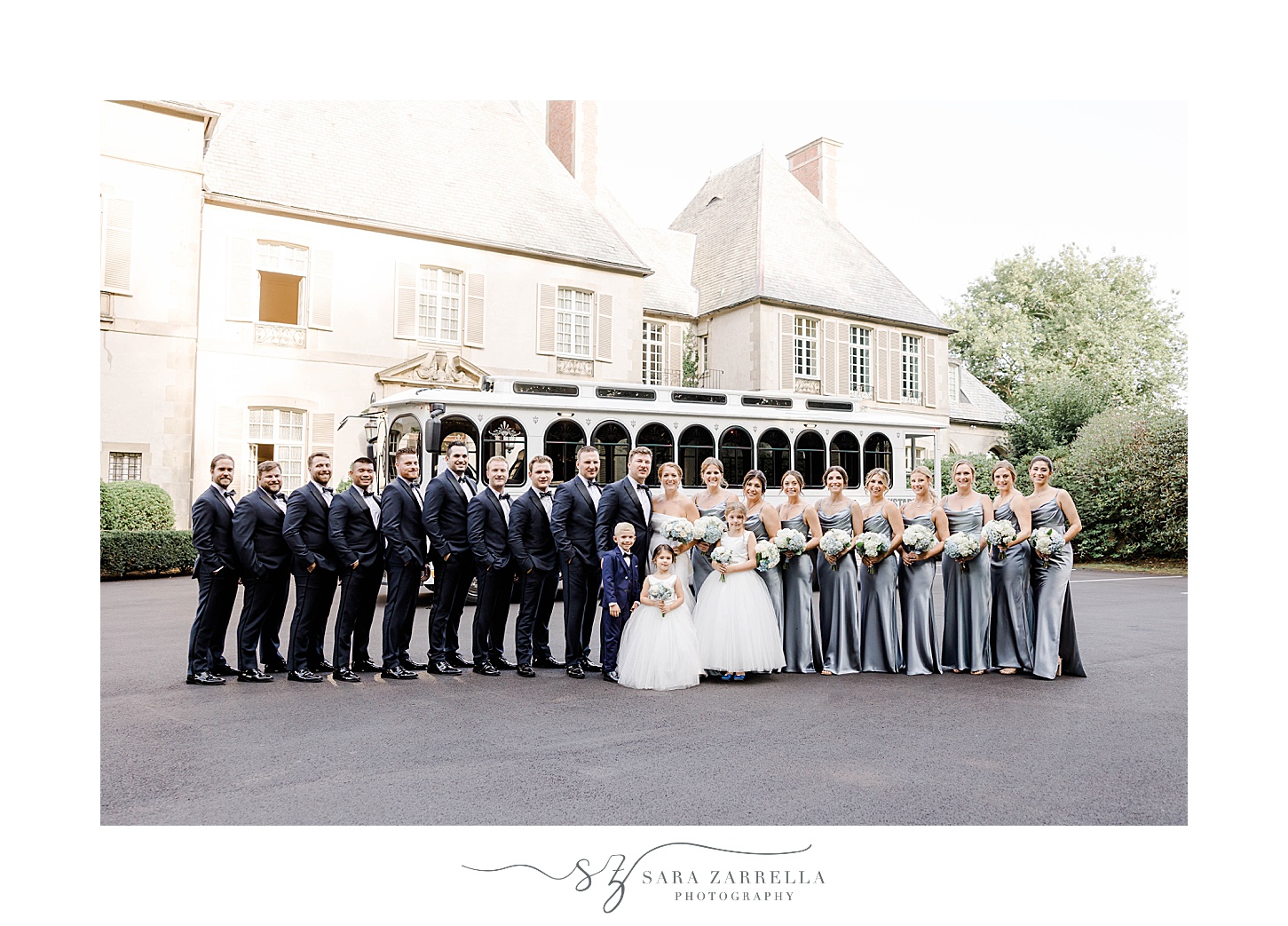 bride and groom stand with wedding party outside Glen Manor House
