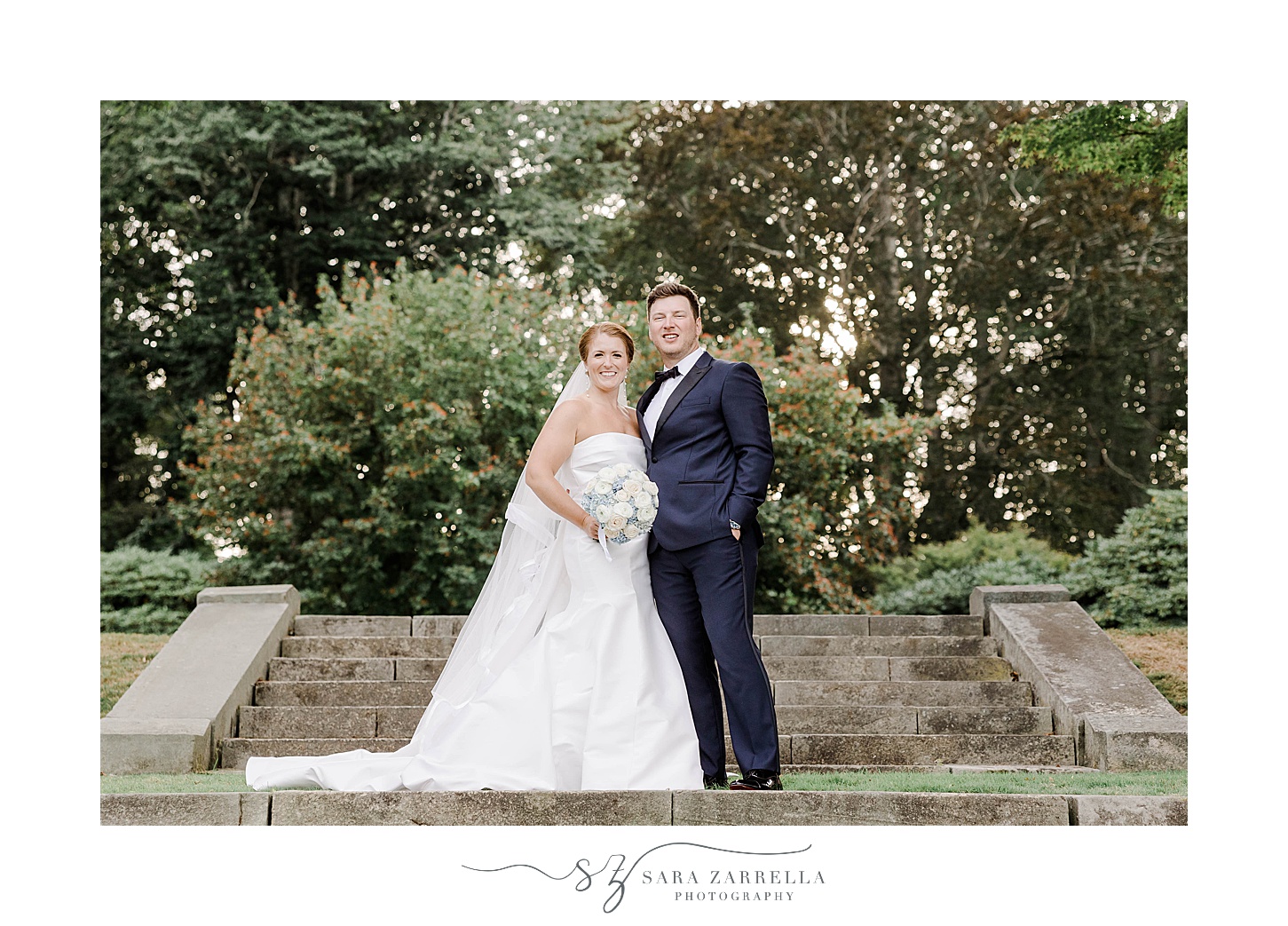 newlyweds stand together hugging on stone steps at Glen Manor House