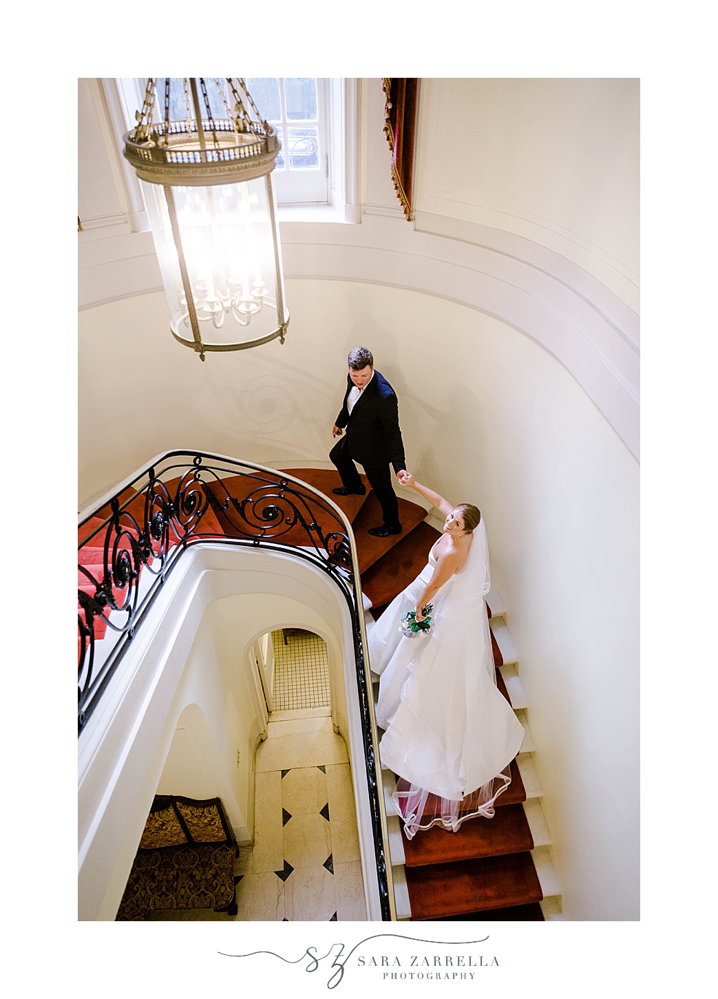 bride and groom hold hands walking up steps inside Glen Manor House