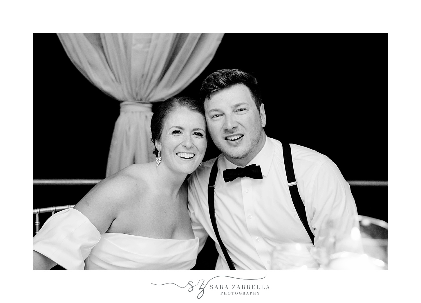 black and white photo of bride and groom at sweetheart table