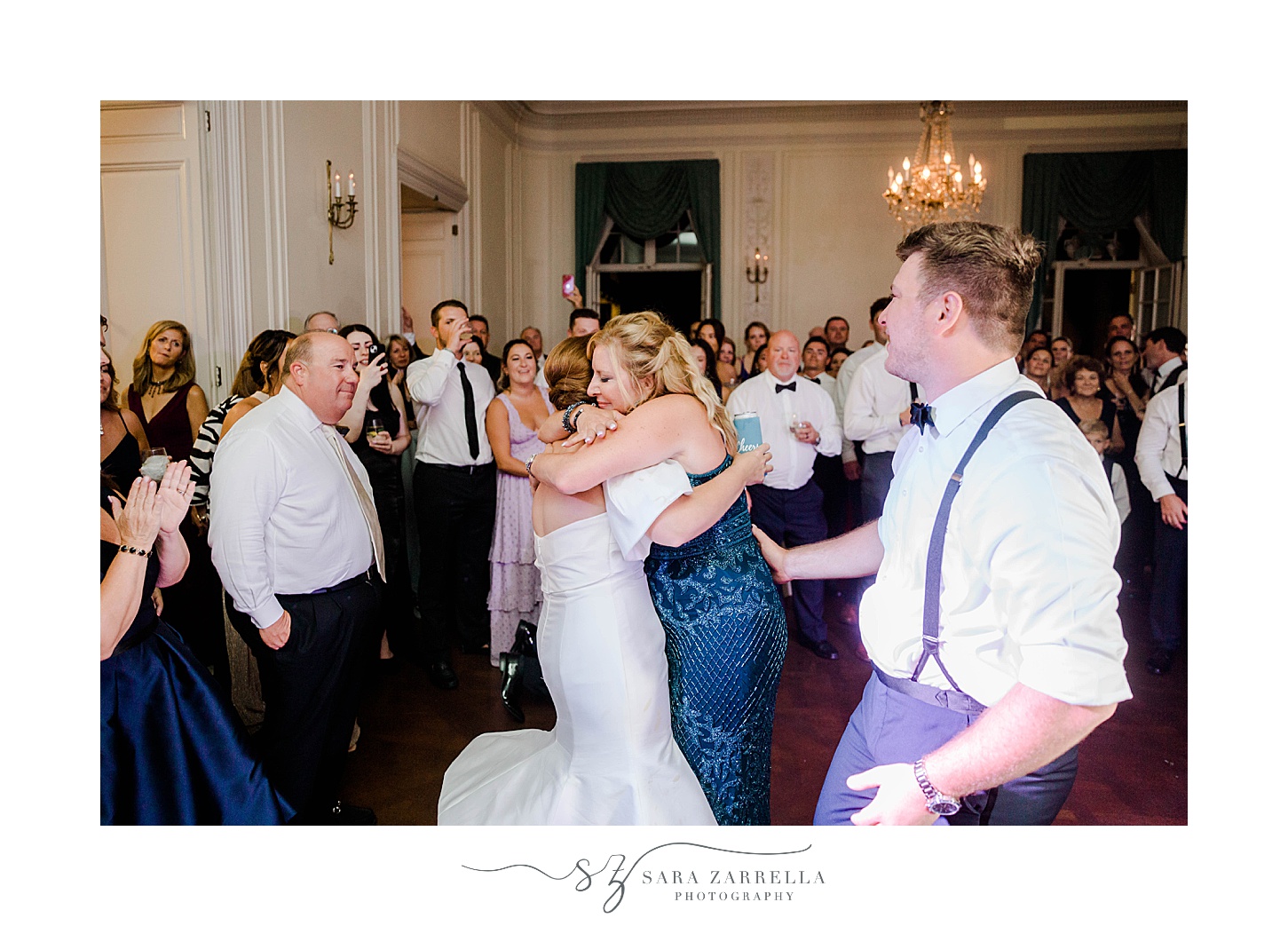 groom in suspenders twirls mom during dance