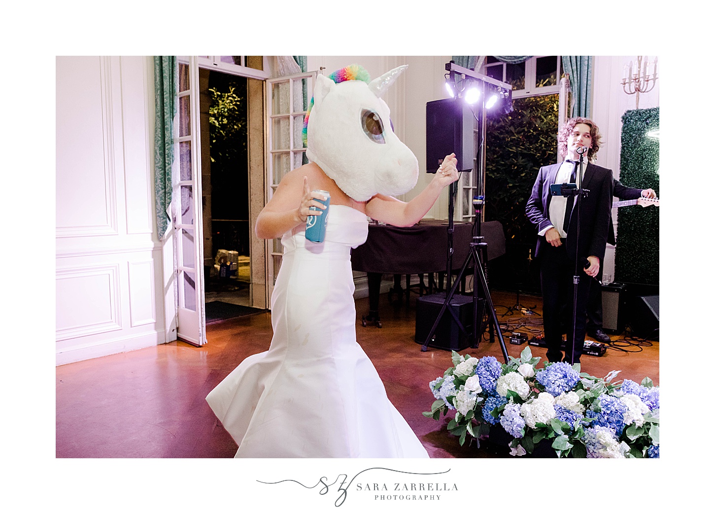 bride in unicorn head dances with band