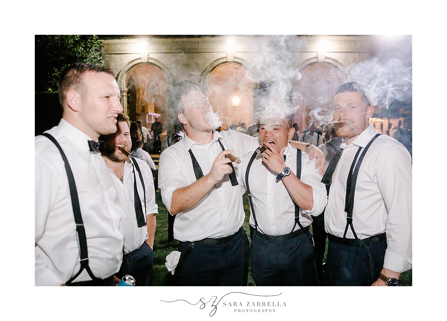 groom and groomsmen smoke cigars in Rhode Island