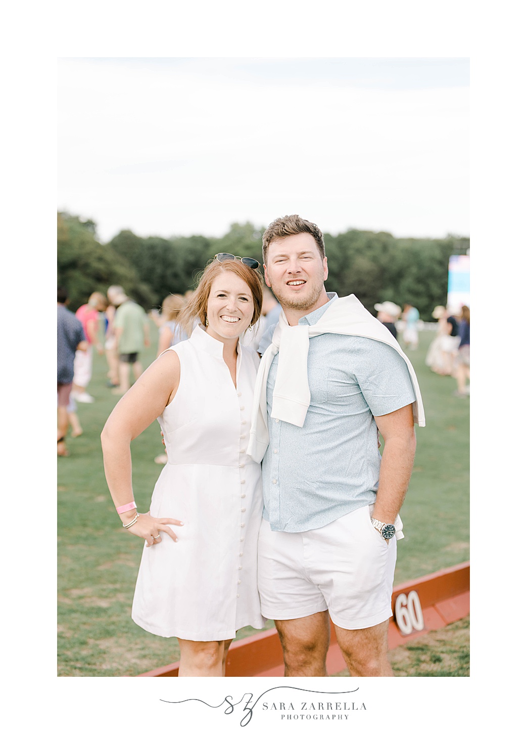 engaged couple poses at Newport Polo match
