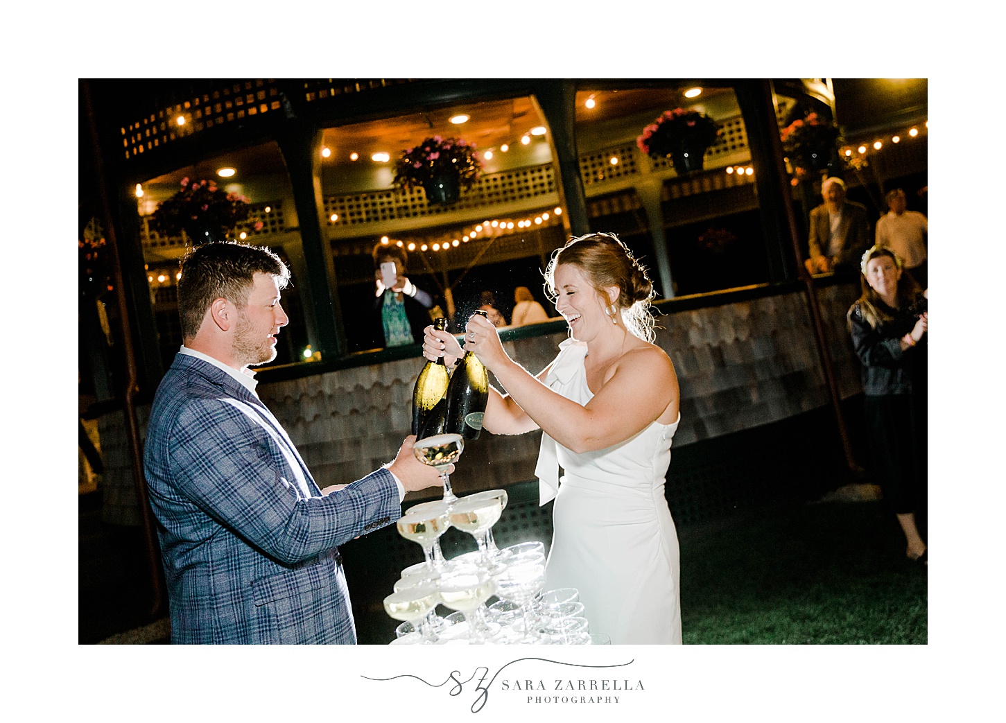 bride and groom pour champagne on tower at welcome dinner