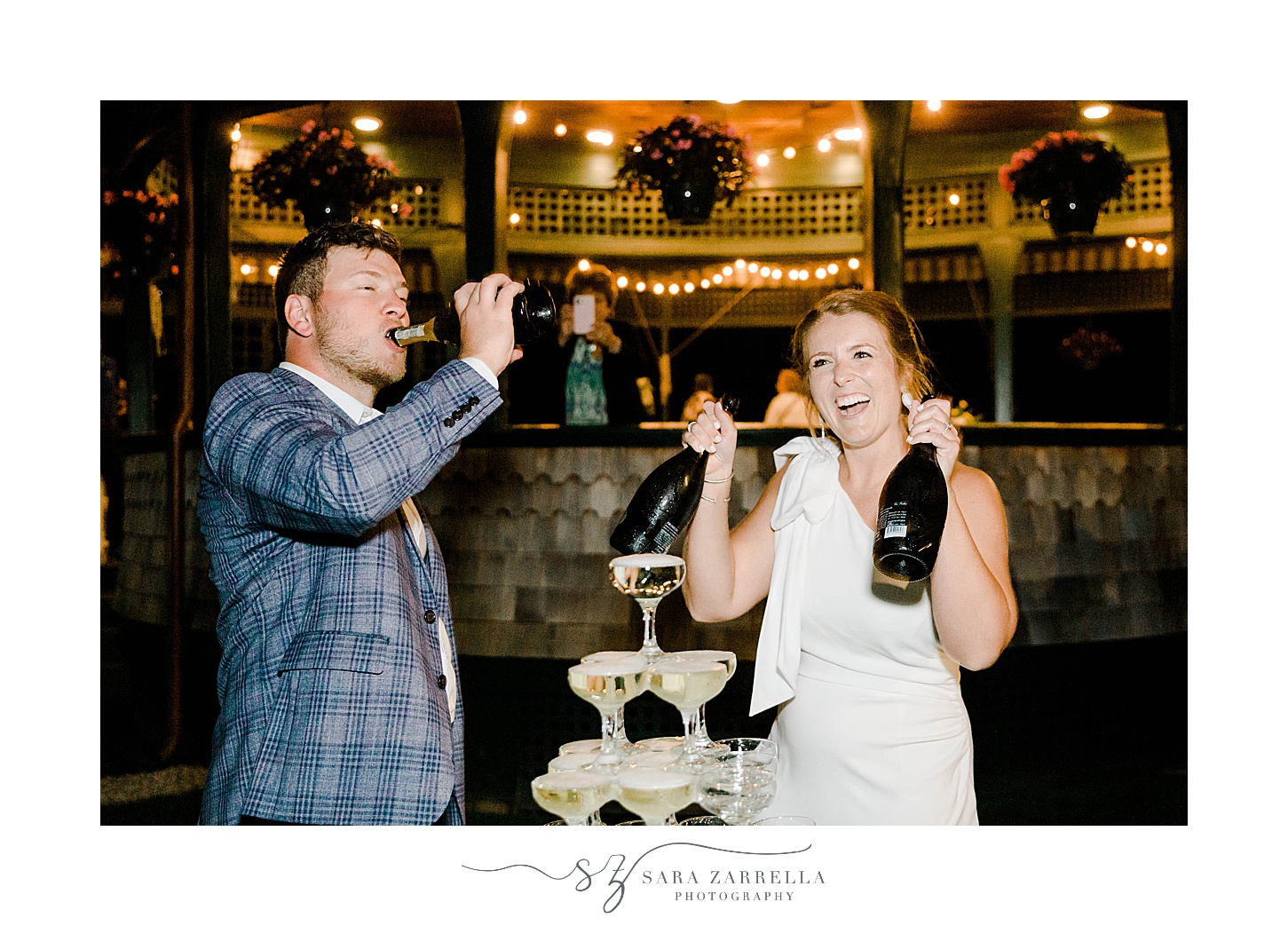 bride and groom pour champagne on tower at welcome dinner
